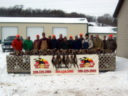 Photo of hunting group with their birds after a successful and enjoyable hunt.