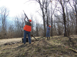 Photo of two hunters shooting at high-flying birds.